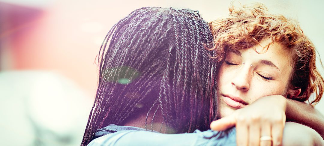 Two girls hugging
